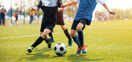 Custom blinds with your photo Two soccer players running and kicking a soccer ball. Legs of two young football players on a match. European football youth player legs in action